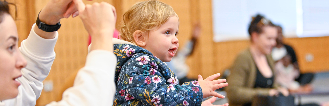 Little girl clapping and enjoying Baby Time.